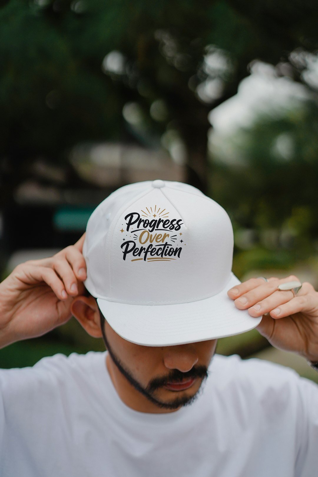 Progress Over Perfection - cap model mockup (man-cap) Model wearing a baseball cap with the "Progress Over Perfection" design